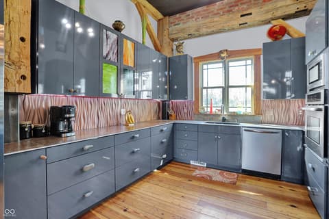 Kitchen at 25811 State Road 19, Arcadia, IN — Modern gray kitchen with rustic wood beam charm.