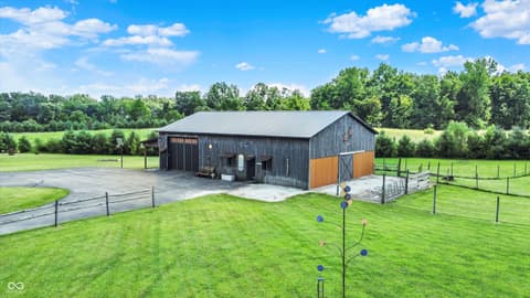 Backyard at 25811 State Road 19, Arcadia, IN — Modern barn on expansive rural property with mature trees.