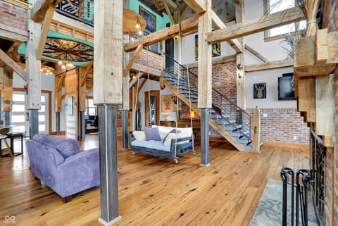 Living room at 25811 State Road 19, Arcadia, IN — Stunning loft with soaring exposed beams and brick.