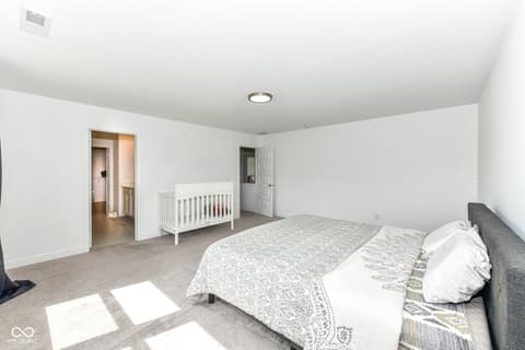 Primary bedroom at 17267 Hanningfield Way, Westfield, IN — Spacious primary suite with ensuite and nursery space.