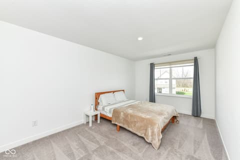 Bedroom at 17267 Hanningfield Way, Westfield, IN — Bright bedroom with large windows and modern finishes.