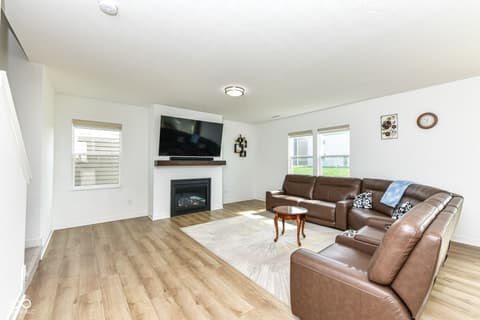 Living room at 17267 Hanningfield Way, Westfield, IN — Spacious living room with fireplace and entertainment setup.