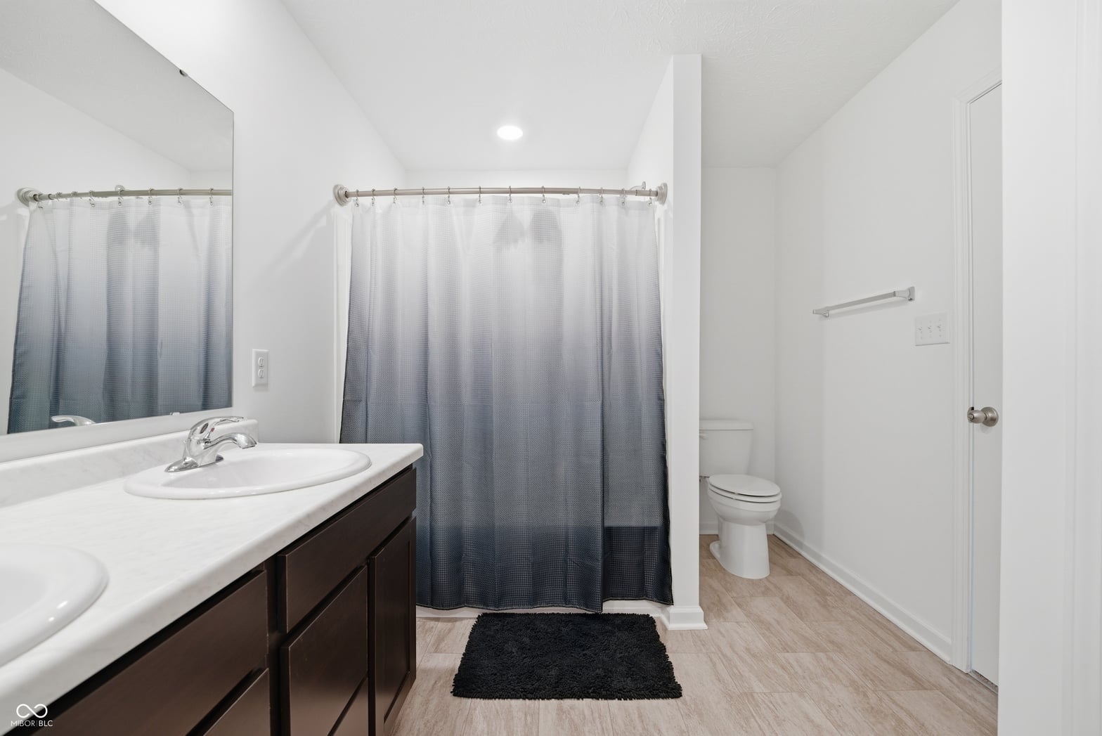 Spacious primary bath with elegant double vanity and modern finishes.