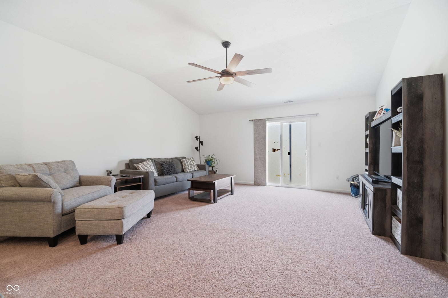Spacious family room with vaulted ceilings and natural light.