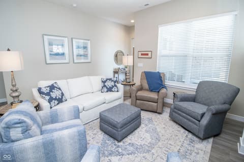 Living room at 15487 Heatherbank Drive, Westfield, IN — Bright coastal-themed living room with quality furnishings.