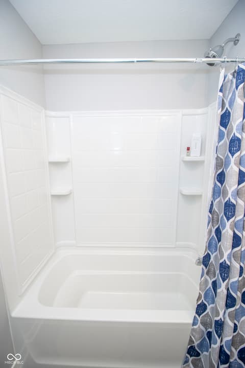 Bathroom at 15487 Heatherbank Drive, Westfield, IN — Fresh, clean bathroom with updated white tile surround.