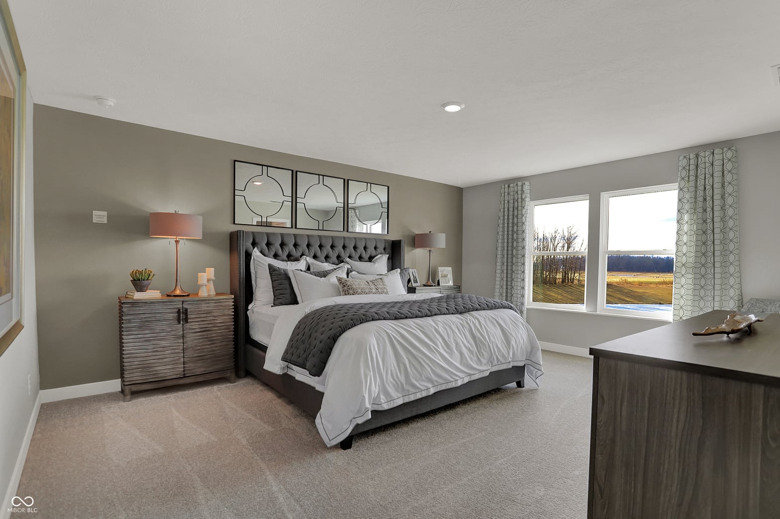 Spacious primary bedroom with scenic views and modern finishes.