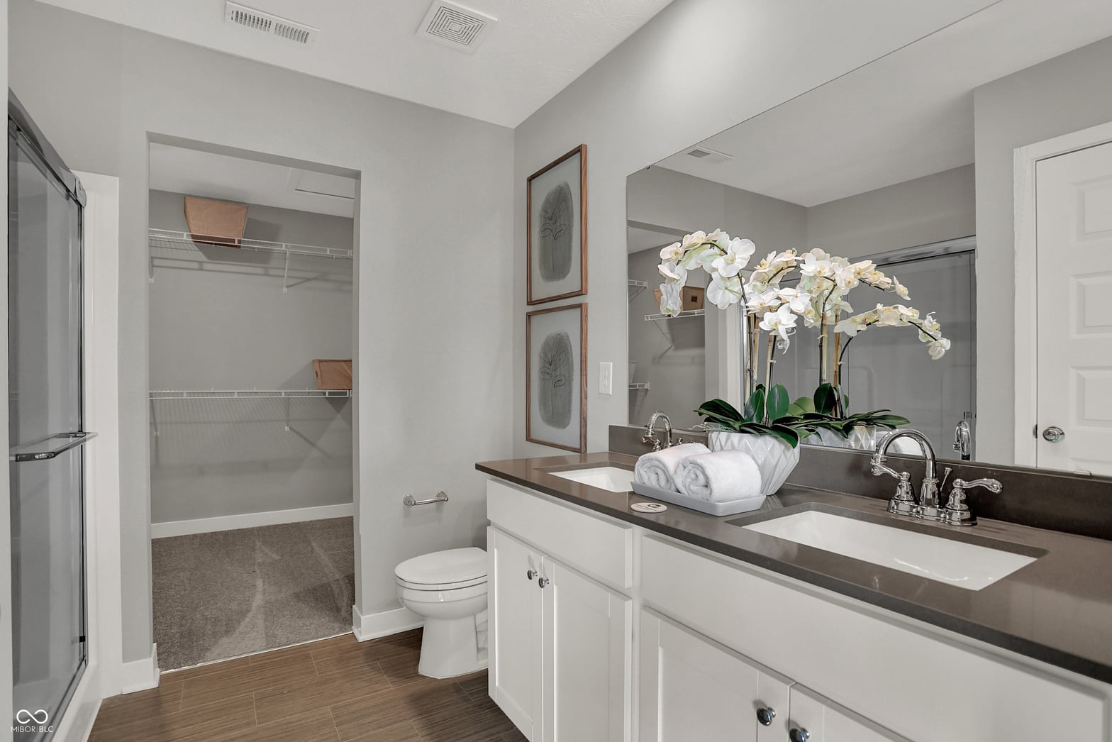 Spa-like primary bath with double vanity and walk-in shower.