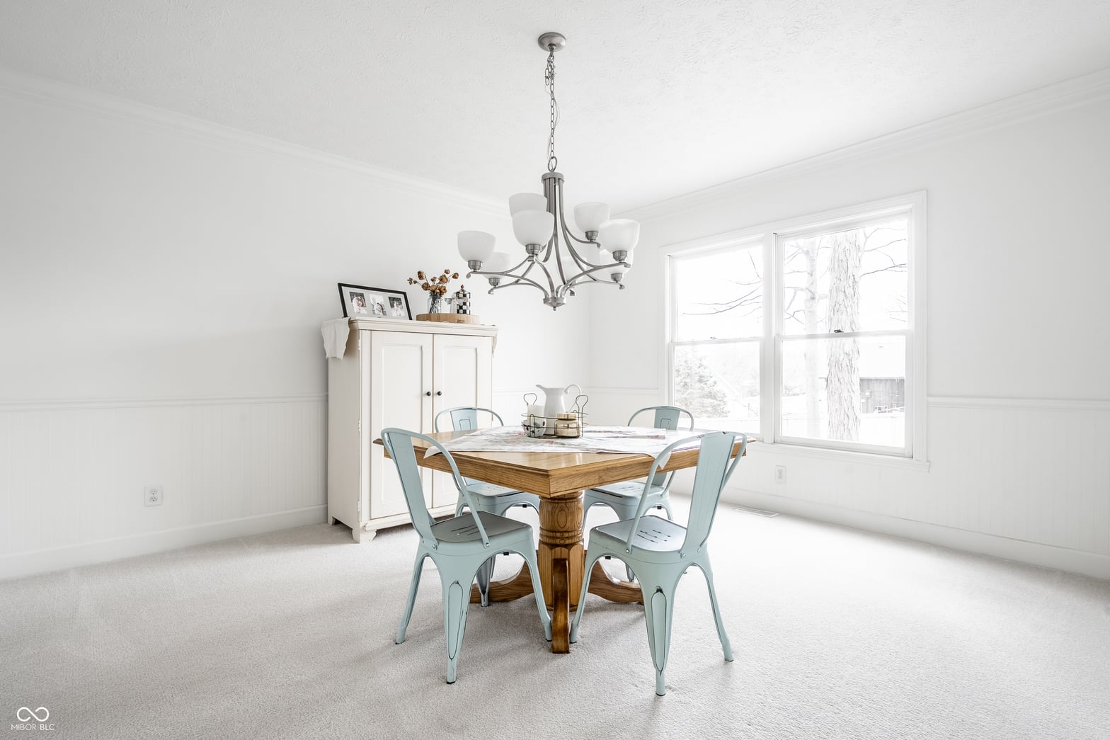 Bright farmhouse dining room with abundant natural light.