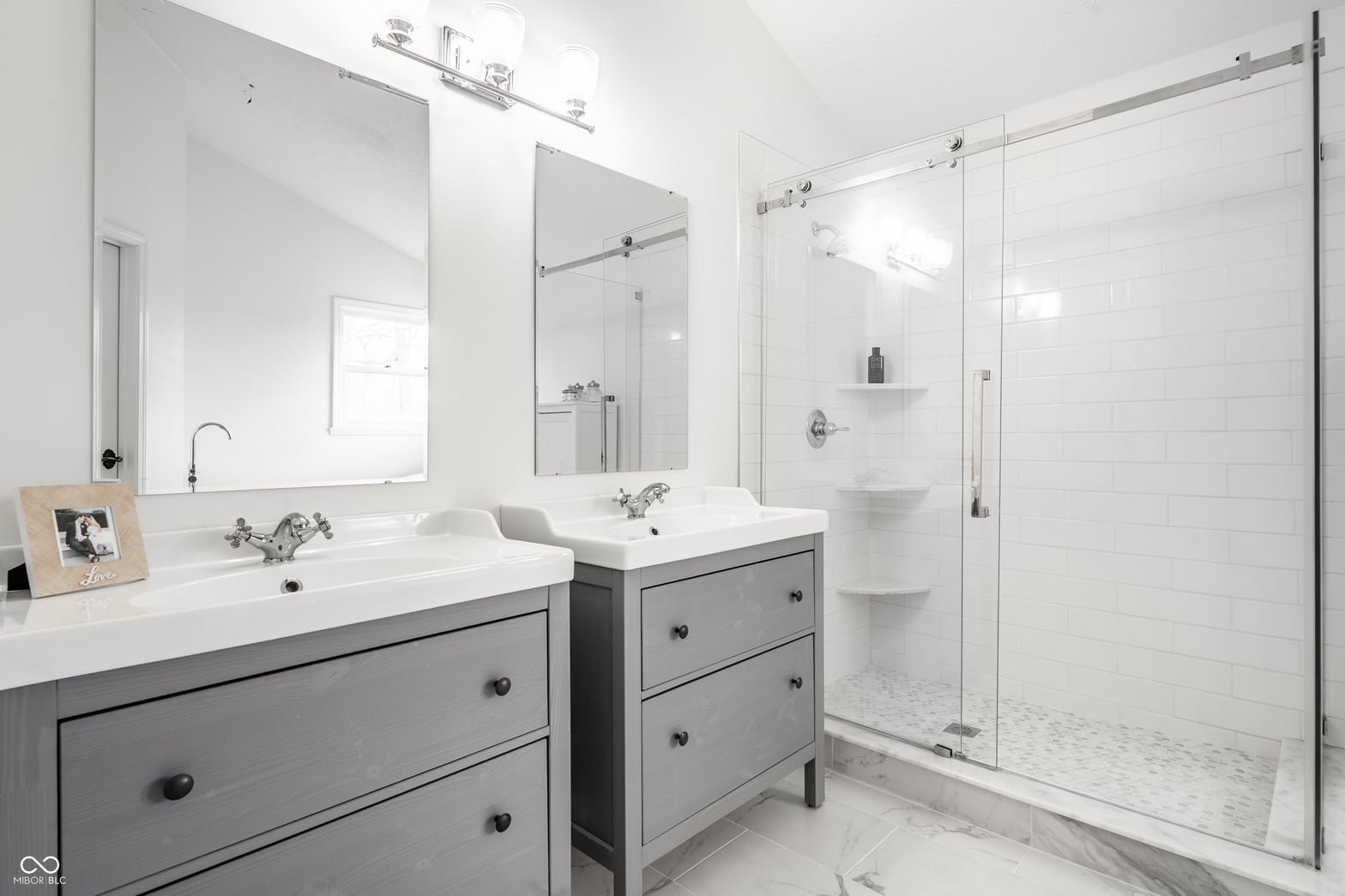Luxurious primary bath with double vanity and walk-in shower.