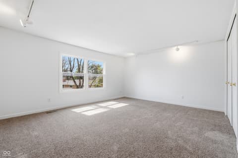 Bedroom at 15 Wildwood Drive, Carmel, IN — Bright bedroom with abundant natural light and windows.