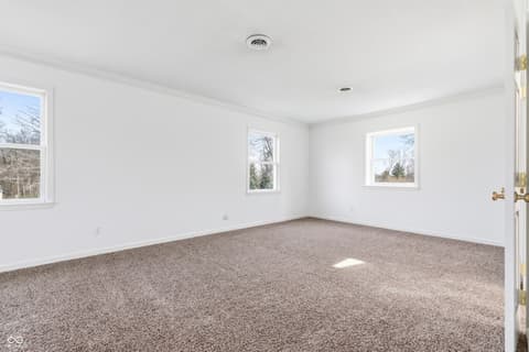 Bedroom at 15 Wildwood Drive, Carmel, IN — Bright, spacious bedroom with abundant natural light.