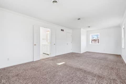 Primary bedroom at 15 Wildwood Drive, Carmel, IN — Spacious primary suite with attached ensuite bathroom.