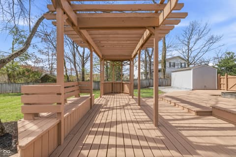 Outdoor living area at 15 Wildwood Drive, Carmel, IN — Spacious multi-level deck with pergola and seating.