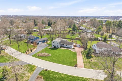 Aerial view at 15 Wildwood Drive, Carmel, IN — Charming colonial on expansive lot with mature landscaping.