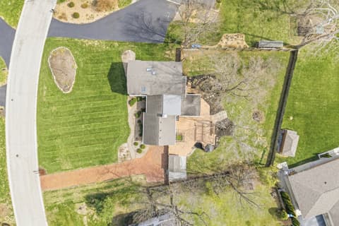 Aerial view at 15 Wildwood Drive, Carmel, IN — Spacious lot with circular landscaping and wooden deck.
