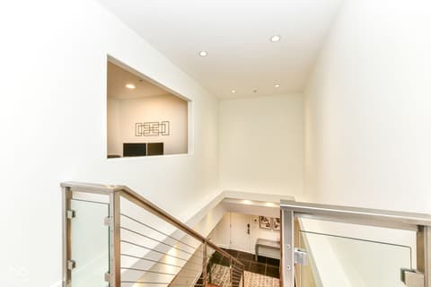 Hallway at 30 W Main Street, Carmel, IN — Contemporary staircase with modern metal and glass railings