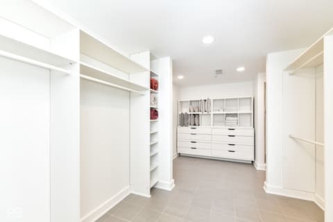 Primary bedroom at 30 W Main Street, Carmel, IN — Luxury walk-in closet with custom shelving and storage.