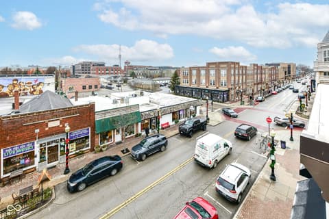 Front exterior at 30 W Main Street, Carmel, IN — Vibrant downtown location with mixed-use brick buildings.