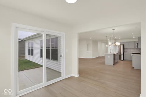 Living room at 19537 Atwater Avenue, Sheridan, IN — Bright open concept with hardwood floors and glass doors.