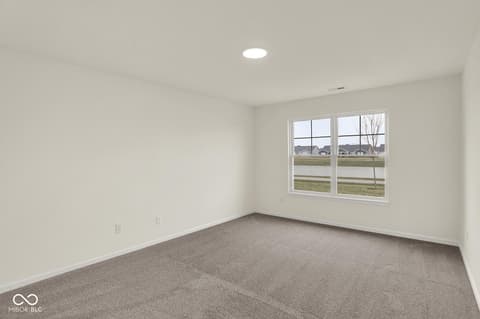 Bedroom at 19537 Atwater Avenue, Sheridan, IN — Bright bedroom with expansive windows and open layout.