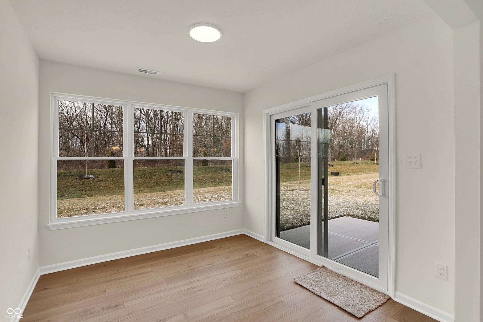Family room at 19488 Atwater, Sheridan, IN — Bright family room with expansive windows and patio access.
