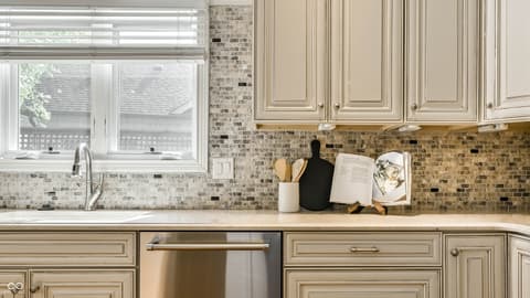 Kitchen at 12344 St Armands Circle, Carmel, IN — Bright updated kitchen with elegant mosaic backsplash.