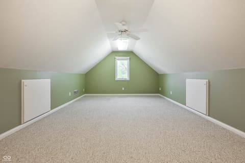 Bonus room at 12344 St Armands Circle, Carmel, IN — Bright bonus room with vaulted ceilings and storage closets.