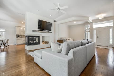 Living room at 12344 St Armands Circle, Carmel, IN — Spacious living room with fireplace and hardwood floors.