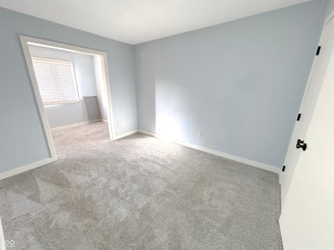 Bedroom at 9728 Revere Way, Indianapolis, IN — Bright bedroom with natural light and balcony access.