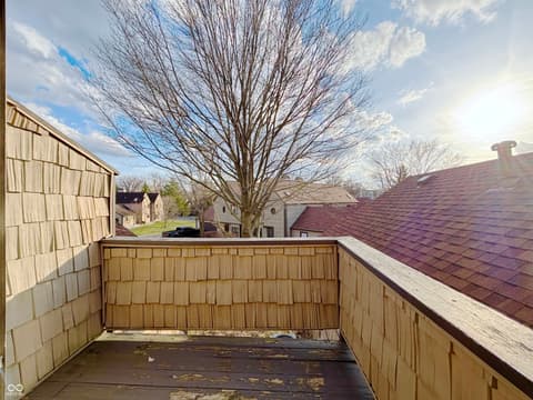 Outdoor living area at 9728 Revere Way, Indianapolis, IN — Rooftop deck with neighborhood views and wood details.