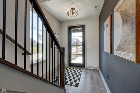 Foyer at 162 Midland Trace Loop, Westfield, IN — Bright modern foyer with dramatic black-framed glass entry.