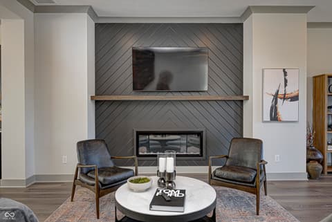Living room at 162 Midland Trace Loop, Westfield, IN — Modern fireplace feature wall with built-in TV mount.