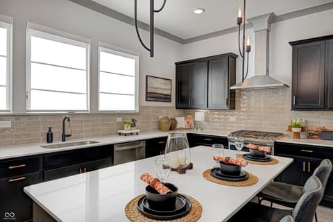 Kitchen at 162 Midland Trace Loop, Westfield, IN — Modern kitchen with black cabinetry and white quartz island.