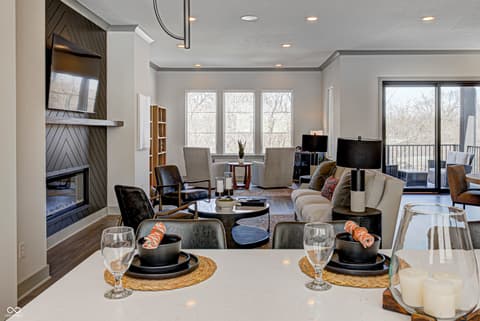 Dining room at 162 Midland Trace Loop, Westfield, IN — Modern open-concept dining and living with fireplace.