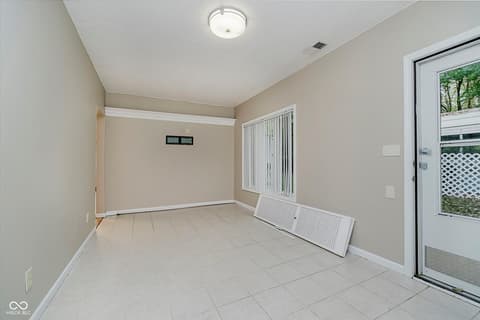 Family room at 9135 E 256th Street, Arcadia, IN — Spacious room with direct outdoor access and natural light.