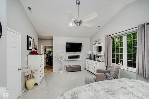 Primary bedroom at 9135 E 256th Street, Arcadia, IN — Luxurious primary suite with fireplace and ensuite bath.