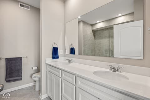 Primary bathroom at 887 Tuxedo Drive, Westfield, IN — Luxurious primary bath with double vanity and glass shower.