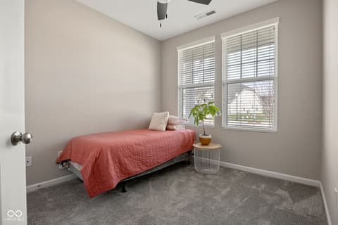 Bedroom at 887 Tuxedo Drive, Westfield, IN — Bright bedroom with large windows and plantation shutters.