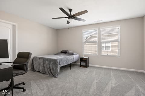 Bedroom at 887 Tuxedo Drive, Westfield, IN — Bright bedroom with plantation shutters and modern fixtures.