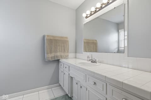 Primary bathroom at 415 Oxford Drive, Noblesville, IN — Bright, spacious primary bath with elegant white cabinetry.