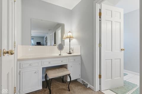 Primary bathroom at 415 Oxford Drive, Noblesville, IN — Luxurious primary bath with double vanity and makeup area.