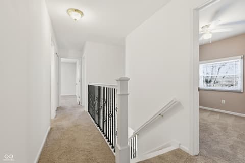 Hallway at 415 Oxford Drive, Noblesville, IN — Bright, open hallway with modern metal railing details.