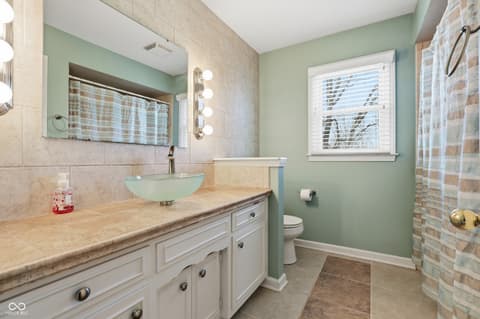 Primary bathroom at 415 Oxford Drive, Noblesville, IN — Spa-like primary bath with granite and vessel sink