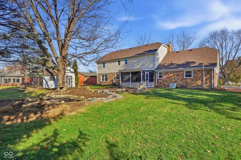 Backyard at 415 Oxford Drive, Noblesville, IN — Spacious backyard with screened porch and mature trees.