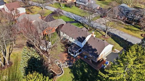 Aerial view at 415 Oxford Drive, Noblesville, IN — Well-maintained home with mature landscaping and deck.
