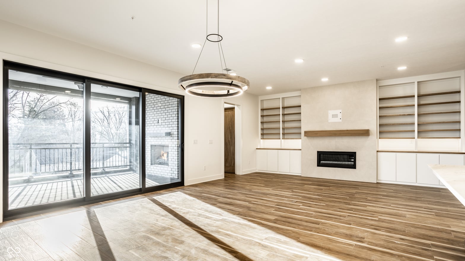 Bright contemporary living space with deck access and fireplace.