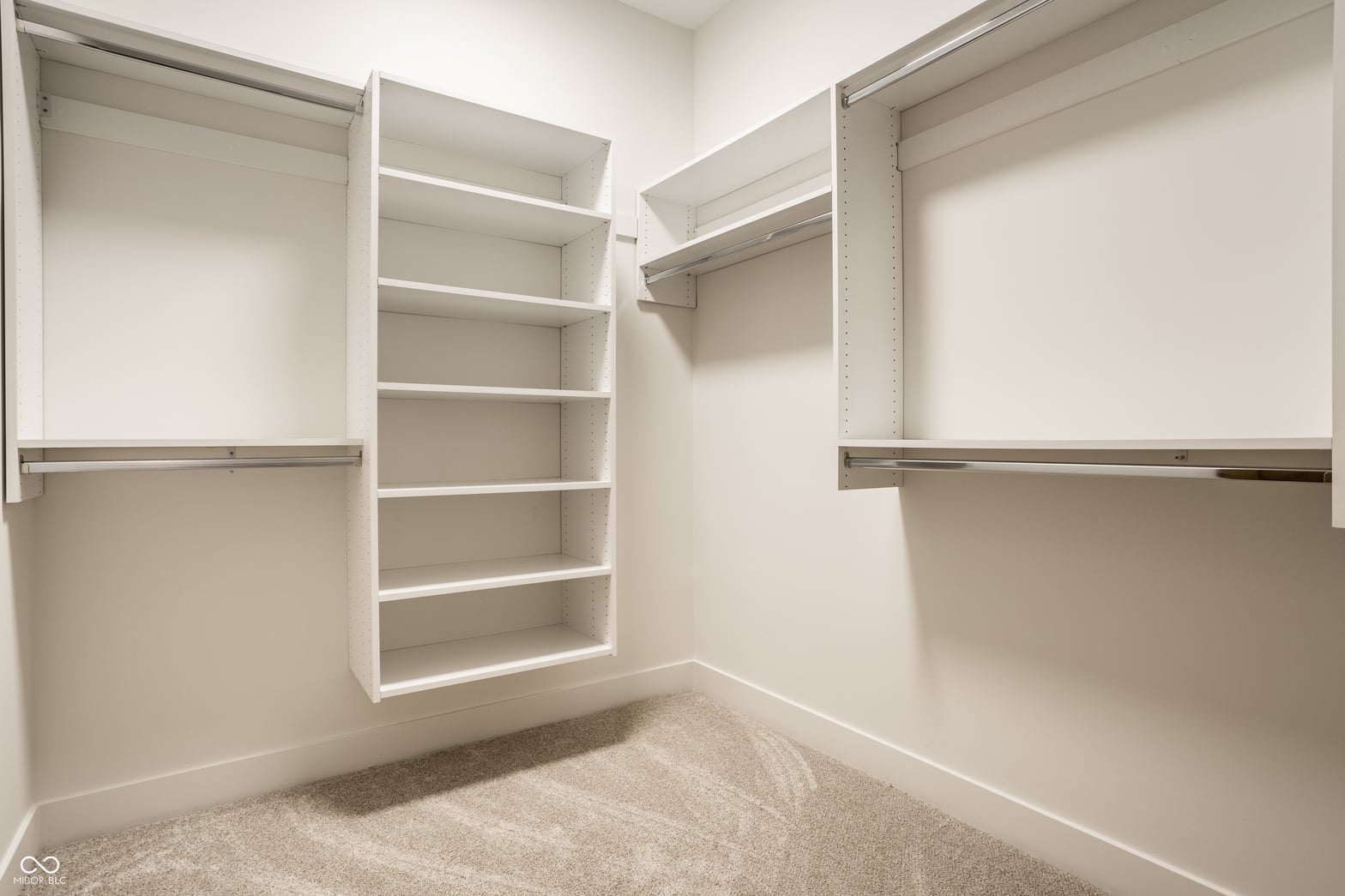 Spacious walk-in closet with organized built-in shelving system.