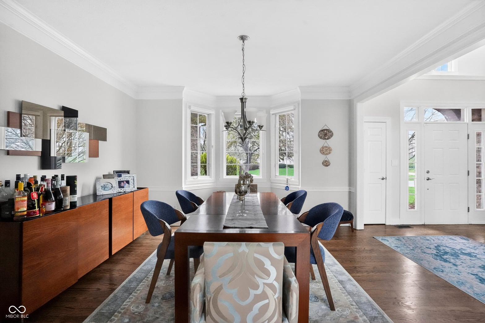 Bright dining room with coffered ceiling and French doors.