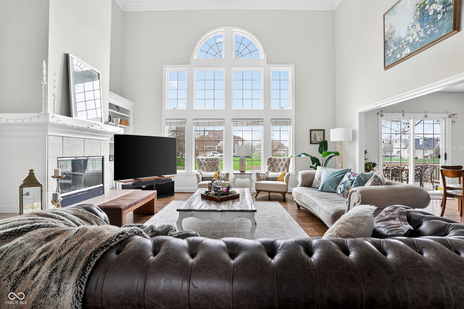 Elegant living room with soaring ceilings and expansive windows.